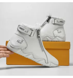Detail of white leather warm boots showing thick faux shearling lining and side zipper