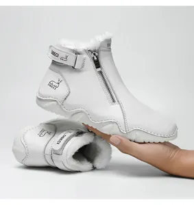 Detail of warm white leather winter boots with faux fur lining and side zipper closure