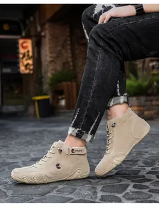 Detail of beige high-top suede shoes with hook-and-loop strap and wave rubber sole