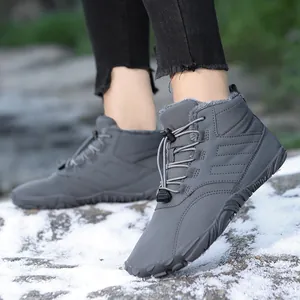 Waterproof winter snow boots with warm faux fur lining and anti-slip rubber soles in snow