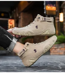 Detail of beige suede high-top boots with wave-edge rubber sole and fox logo