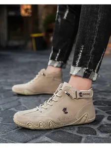 Detail of khaki suede high-top outdoor shoe with secure strap and rugged non-slip sole