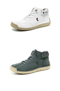 Detail view of high-top sneakers showing side fox logo and rubber sole stitching