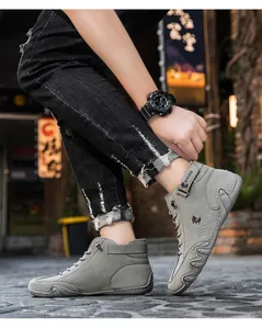 Close-up of gray high-top casual shoe with DYCOO strap and side fox logo detail