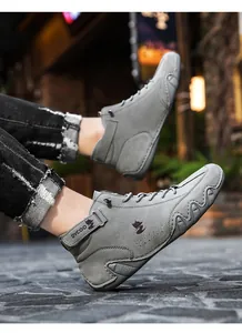Detailed close-up of grey high-top casual sneakers with textured rubber non-slip soles