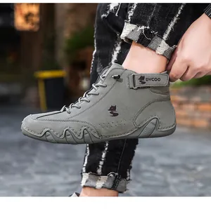 Detail of grey high-top casual boots with nubuck leather and a wave-textured rubber sole