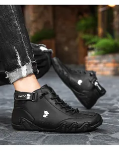 Close-up of black high-top sneakers with white fox logo and wave-textured sole detail