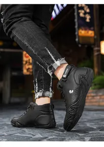 Detail of high-top black casual leather sneakers with side logo and anti-slip thick soles