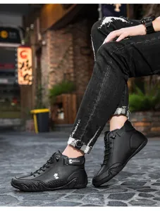 Close-up of black high-top casual leather boots with lace-up and velcro closure details