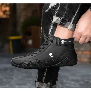 Close-up of black high-top sneakers with rubber sole and side strap detail