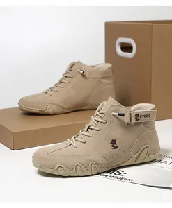 Detail of khaki suede high-top sneakers with lace-up design and rubber soles