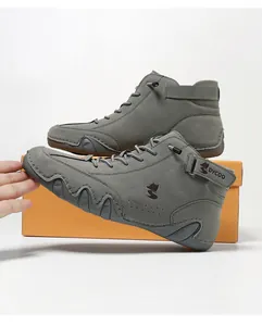 Detailed view of high-top grey casual boots featuring rubber toe cap and side logo