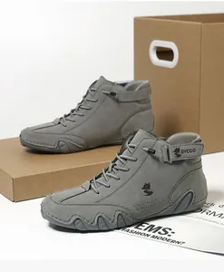 Close-up of grey suede high-top sneakers with durable rubber soles and Velcro straps