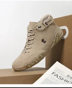 Detail of khaki suede high-top outdoor boots featuring a fox logo and anti-slip sole