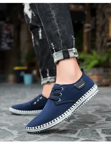 Detailed side view of navy blue canvas sneakers with white braided sole stitching
