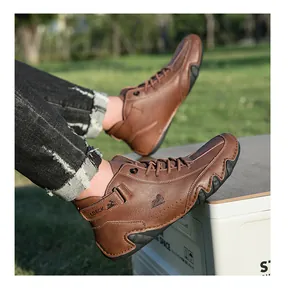 Close-up of brown high-top leather boots featuring side logo and rugged rubber soles
