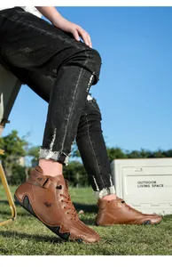 Outdoor shot of men's brown leather high-top boots with buckle and LOECK logo detail