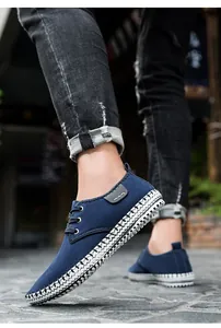 Detailed side view of navy canvas casual shoe with unique woven platform sole on street