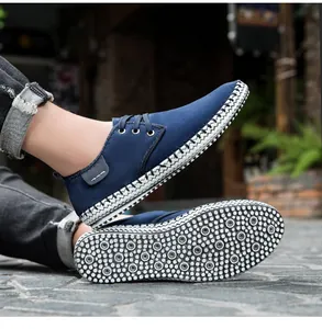 Detail of navy blue men casual shoes showing non-slip rubber sole and white stitching