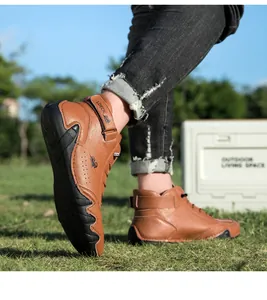 Detail of brown leather high-top boots with velcro straps and non-slip rubber soles