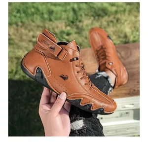 Detailed close-up of brown leather high-top boots with LDECK logo and wave rubber sole