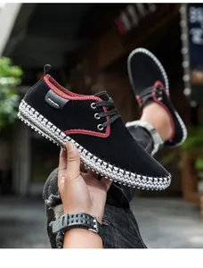 Detail of black nubuck casual shoe with red collar trim and woven sole edge texture