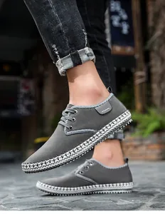 Detail shot of men's grey casual shoes with unique woven sole edge in street scene