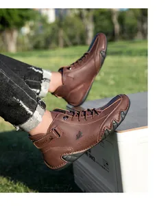 Outdoor shot of brown high-top leather casual boots featuring rubber soles and LDECK logo