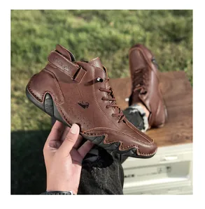 Detail of dark brown leather men's ankle boots with litchi texture and LDECK logo