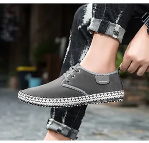 Detail of dark grey handmade casual shoes featuring distinct thick hand-stitched seams