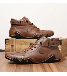 Close-up of brown high-top leather work boots with buckle strap and anti-slip rubber sole