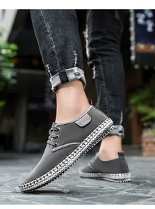Detail of dark grey suede casual shoes with handcrafted woven texture on the sole edge