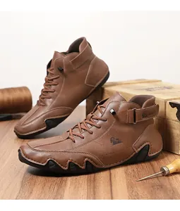 Detail of brown leather lace-up boots with LDECK logo on vintage wooden background