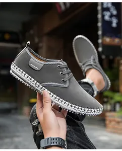 Detail of dark gray men shoes with unique black and white woven pattern on the sole edge