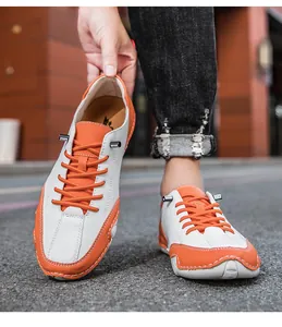Vue détaillée des chaussures en cuir à blocs de couleurs avec lacets orange et surpiqûres