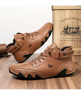 Close-up of brown leather high-top boots with textured finish and velcro strap detailing