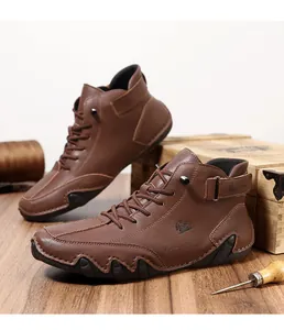 Detailed close-up of brown leather boots with side buckle and embossed goat logo