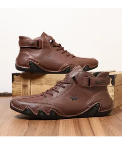 Detail of LDECK brown leather boots showing fine stitching and high-top velcro strap