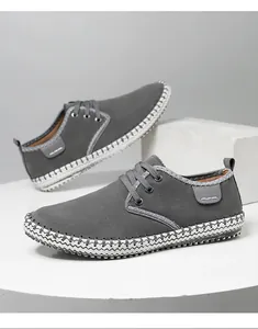 Detail view of handmade grey suede casual shoes featuring white contrast decorative stitching