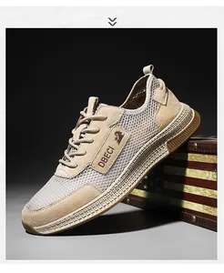 Close-up of breathable mesh fabric and leather upper on khaki men outdoor casual sneakers