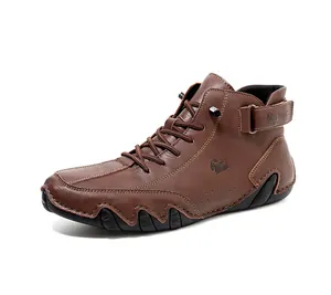 Close-up of brown high-top boots with embossed ram logo and adjustable velcro ankle strap