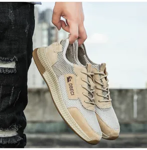 Detail of khaki leather mesh sneakers showing breathable honeycomb fabric and suede texture