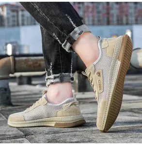 Close-up of beige breathable mesh and premium leather panels on outdoor casual shoes