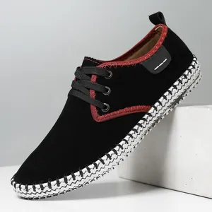 Men's casual black suede shoes with red stitching details on white geometric base