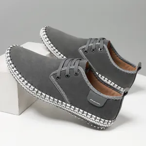 Men's dark gray suede lace-up sneakers with decorative woven sole edge detail