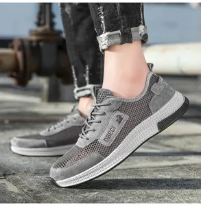 Men's grey breathable mesh leather sneakers shown in an outdoor casual setting