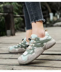 Outdoor-Aufnahme hellgrüner Ledersneaker mit Kordelzug auf einem Holzsteg