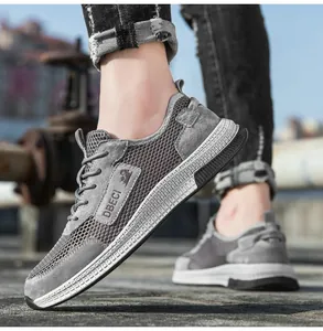 Detail view of grey breathable mesh sneakers with leather logo and non-slip rubber sole