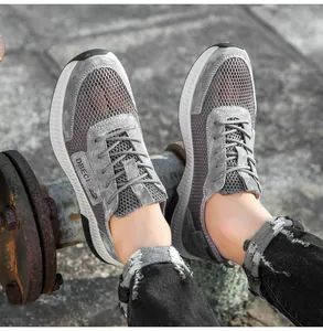 Detail of grey mesh and suede casual men's sneakers with chunky white cushioning sole