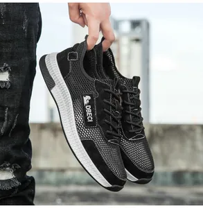 Close-up of black breathable mesh and leather upper on premium outdoor men's sneakers